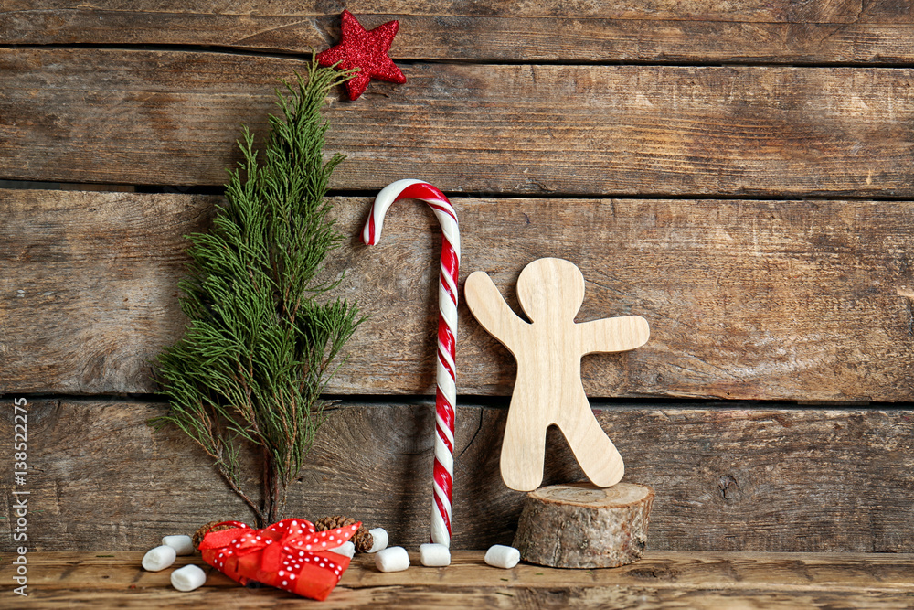 Christmas composition with candy cane and decorations on wooden background