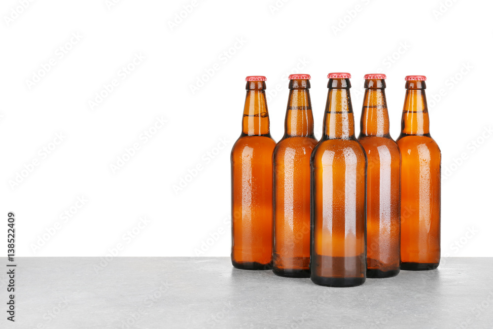 Bottles of beer on table against white background