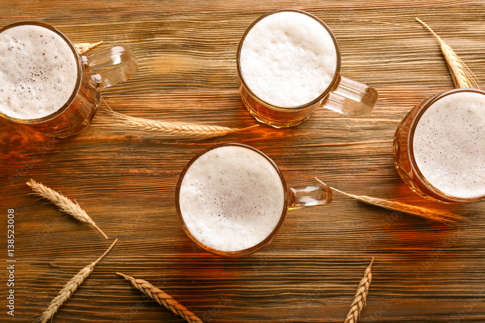 Glasses with beer on wooden background