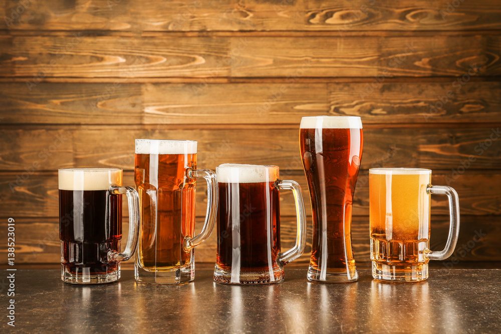 Glasses with beer on wooden background