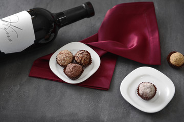 Sticker - Delicious chocolate truffles and red wine on grey background