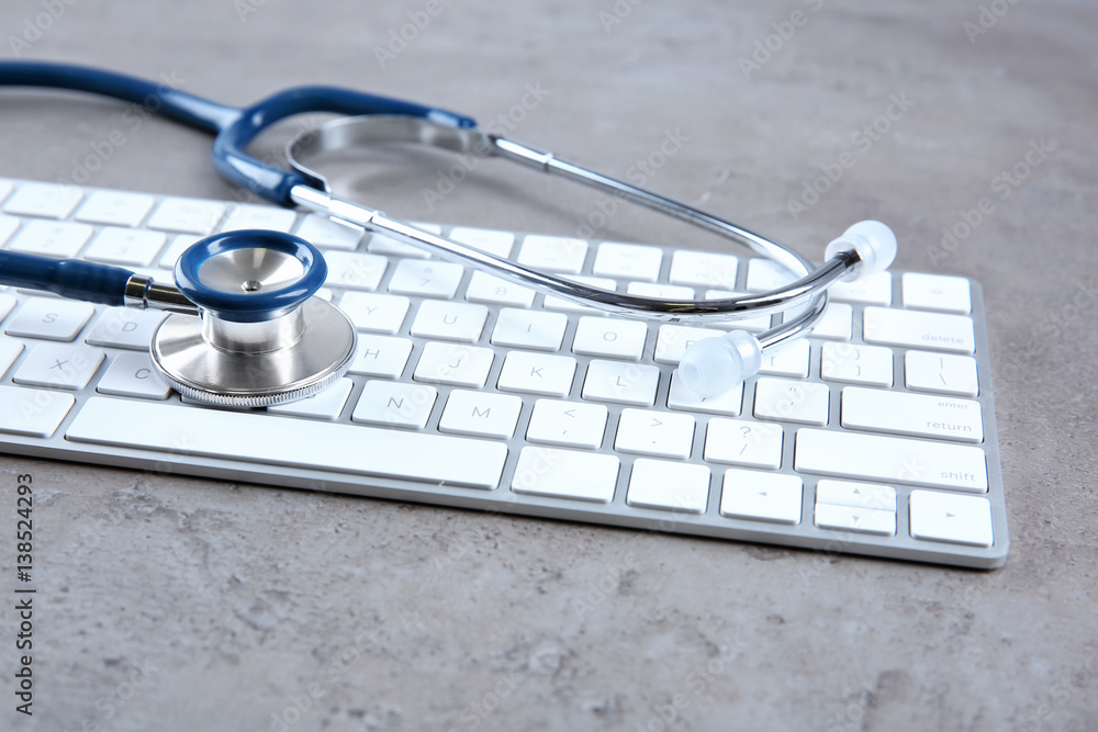 Stethoscope on computer keyboard, closeup
