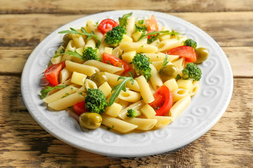 Sticker - Pasta salad with tomatoes and olive on wooden background