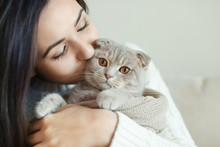 Beautiful Young Woman With Cute Cat Resting At Home