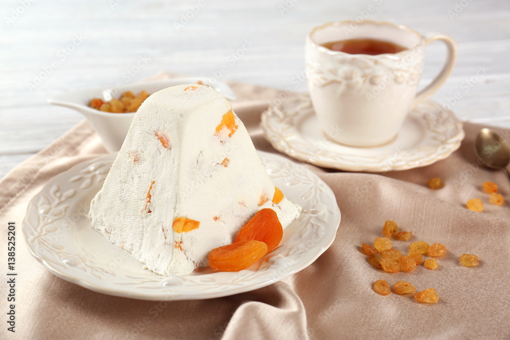 Plate with traditional Easter curd dessert on table