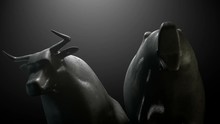A Closeup Pan Around Two Metal Castings Depicting A Stylized Bull And A Bear Head In Contrasting Light Representing A Financial Market Trends On A Dark Dramatic Background