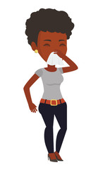 Wall Mural - Young african-american sick woman sneezing.