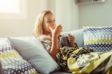 Canvas Print - Girl in blanket relaxing on couch in living room