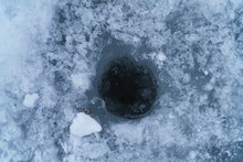 Hole In Ice On A Lake For Winter Fishing, Closeup Photo