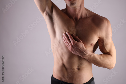 Zdjęcie XXL Zbliżenie mięśni męskiej torsu, klatki piersiowej i usuwania włosów pod pachami. Mężczyzna woskowanie