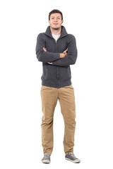 Wall Mural - Happy man with crossed arms wearing gray zip sweater and ochre pants. Full body length portrait isolated over white background.