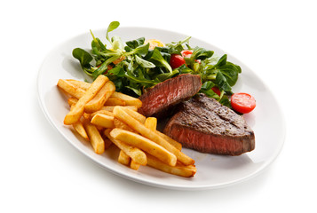 Wall Mural - Grilled steak, French fries and vegetables 