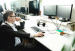 © Aleksandr - Man working at a computer in the office with monitors