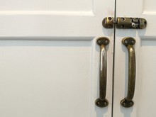 Modern Vintage Style Door Handle And Slide Lock On White Natural Wooden Door, White Door Space On The Left With Lock And Handle On The Right