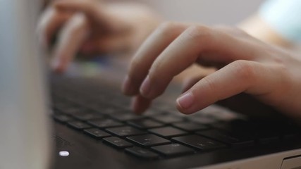 Close-up of children's hands typing on a keyboard