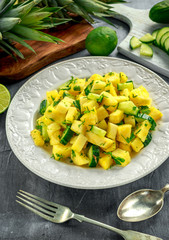 Wall Mural - Fresh Juicy Pineapple Cucumber salad on white plate