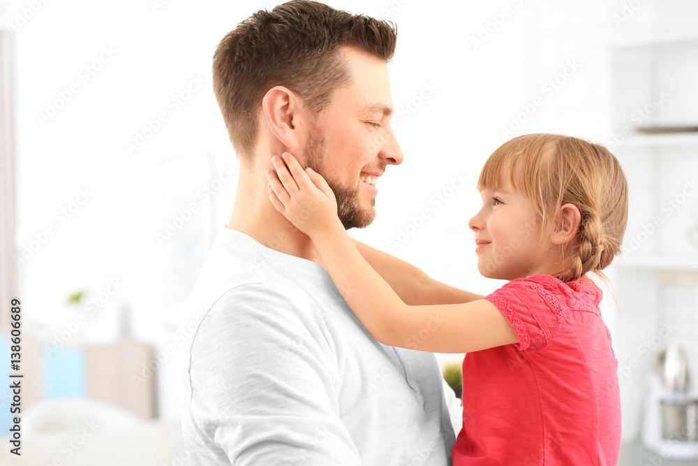 Girl embracing father at home