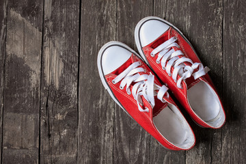 red sneakers on wooden background. Concept of Sport, Work out, Training. Toned image.