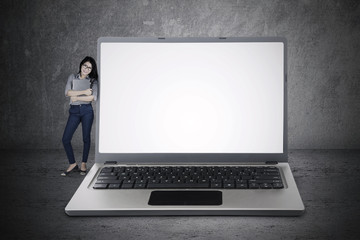 Wall Mural - Woman standing with copy space on laptop