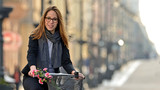 Fototapeta Miasto - Young woman on a bicycle.