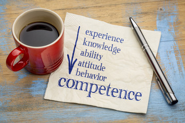competence concept on napkin with coffee