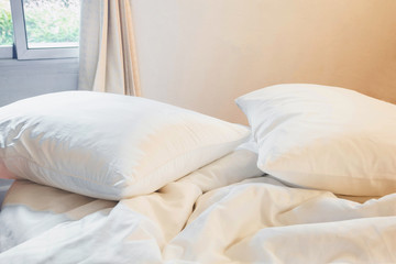 Wall Mural - white pillow and blanket with wrinkle messy on bed in bedroom with lighting upper left side, from sleeping in a long night winter.