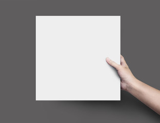 Woman hand holding blank paper sheet or design paper on black background.