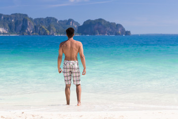 Wall Mural - Young Man On Beach Summer Vacation, Guy Standing Back Seaside Blue Water Sea Ocean Holiday Travel