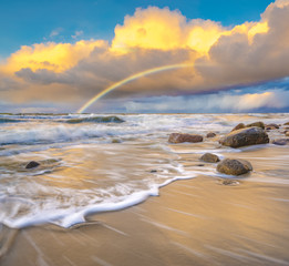 Wall Mural - beautiful colored storm clouds over the sea beach, rainbow