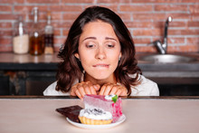 Woman On The Diet Craving To Eat Cake