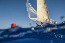 Sailing Boat With Spinnaker On Windward Mark - Red Buoy. Waterline View. 