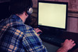 © alexkich - male behind computer with headphones
