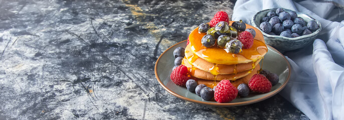 stack of pancakes with fresh blueberry and maple syrup
