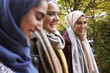 Three smiling woman wearing hijabs