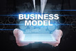 © WrightStudio - Businessman holding tablet PC with business model concept.