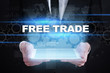 © WrightStudio - Businessman holding tablet PC with free trade concept.