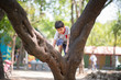 © wckiw - Little boy tryingto hang on the tree