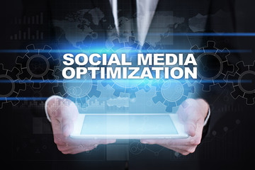 Wall Mural - businessman holding tablet pc with social media optimization concept.