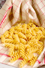 Wall Mural - Pasta in a towel on a wooden table