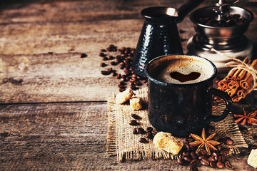 Old coffee cup and mill on dark rustic background