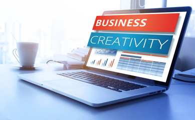Wall Mural - business creativity text on laptop screen with graph chart background.business marketing,success and