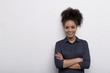 © Artem Varnitsin - Female entrepreneur standing at wall with her arms crossed, wearing shirt