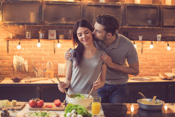 Young couple cooking in kitchen