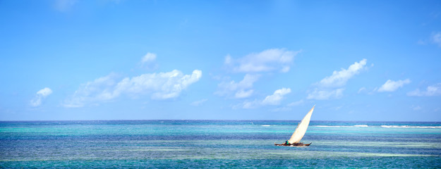 Wall Mural - Panoramic view of ocean waters with traditional dhow boat in Zanzibar