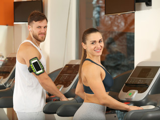 Wall Mural - Young people running on treadmills in gym