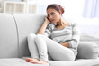 © Africa Studio - Depressed young woman on sofa at home