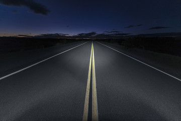 Quiet Mojave desert portion of Route 66 at night in Southern California.    