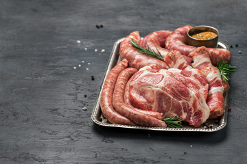 Wall Mural - Set of different meat products on dark surface