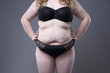 © staras - Plus size model in black lingerie, overweight female body, fat woman with stretch marks on gray background