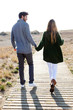 © nenetus - Beautiful young couple in love walking in a cold winter on the beach.